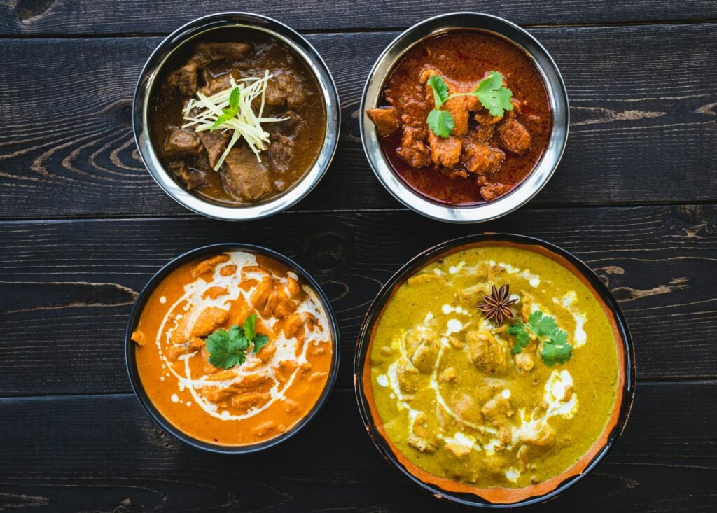 bowls of mouth watering indian food on a wooden table