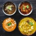 bowls of mouth watering indian food on a wooden table