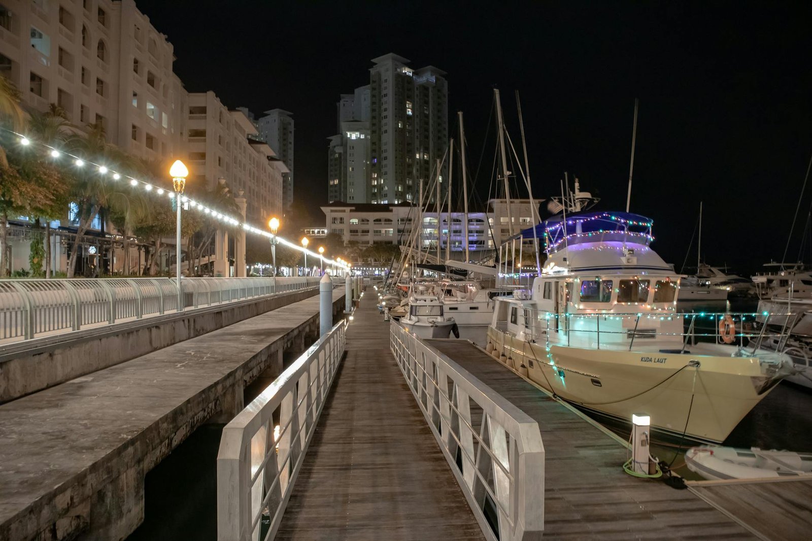 yachts docked on a pier during nighttime