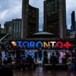 people gathered in front of toronto freestanding signage