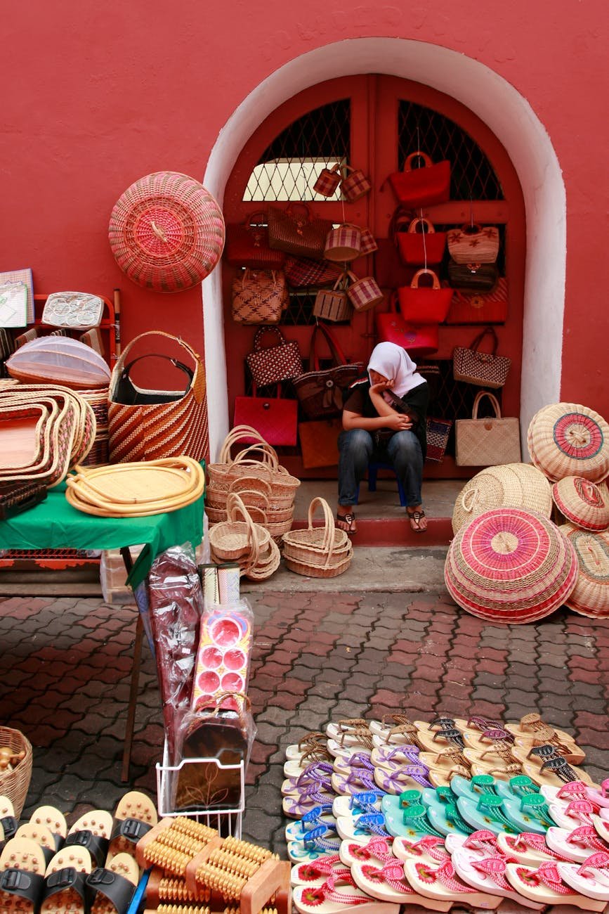 woman selling wickerwork and sandals at a street stall