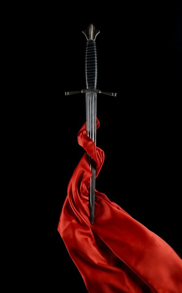 dagger with a blade wrapped in red silk