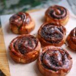cinnamon rolls on a wooden tray