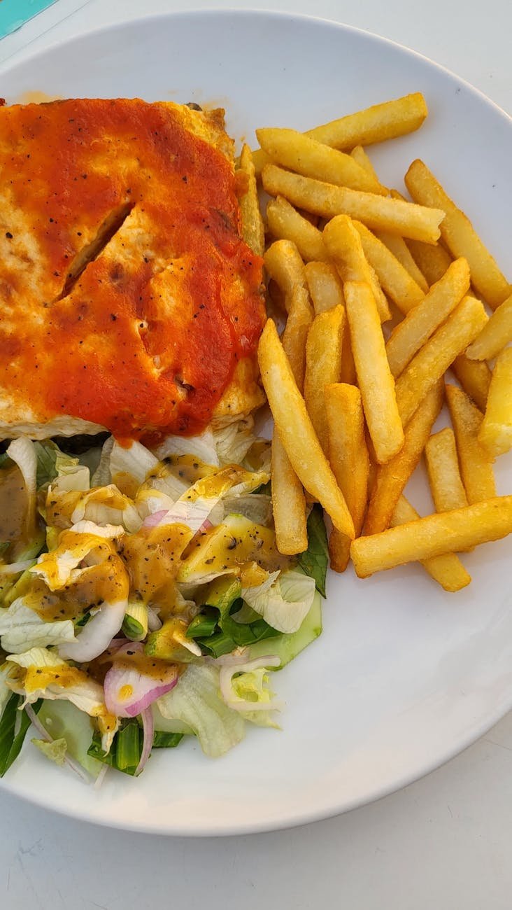 delicious lasagna with french fries and salad