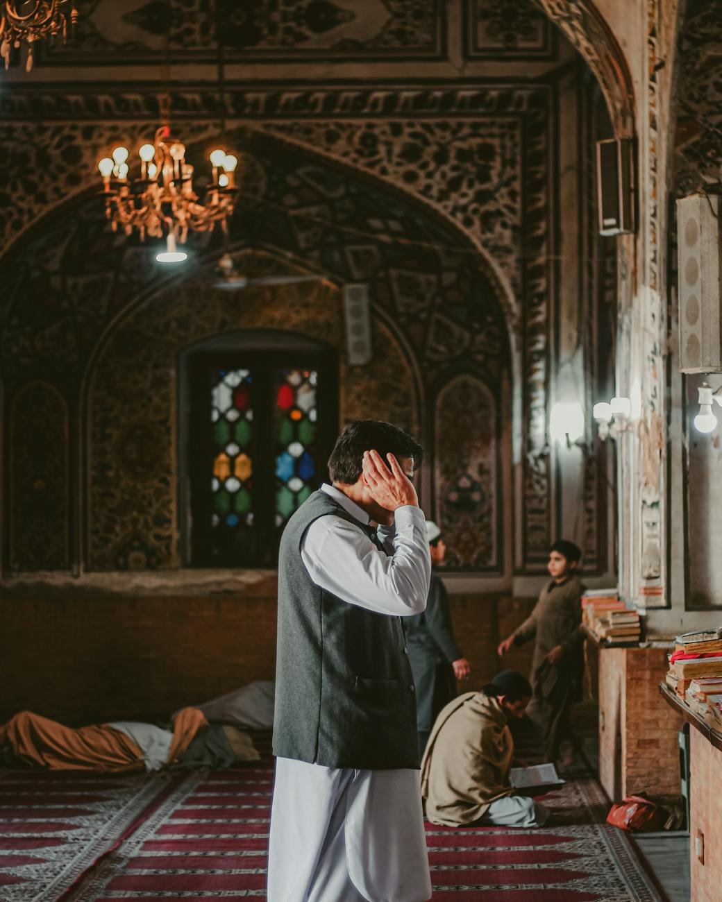 people praying in historic peshawar mosque interior