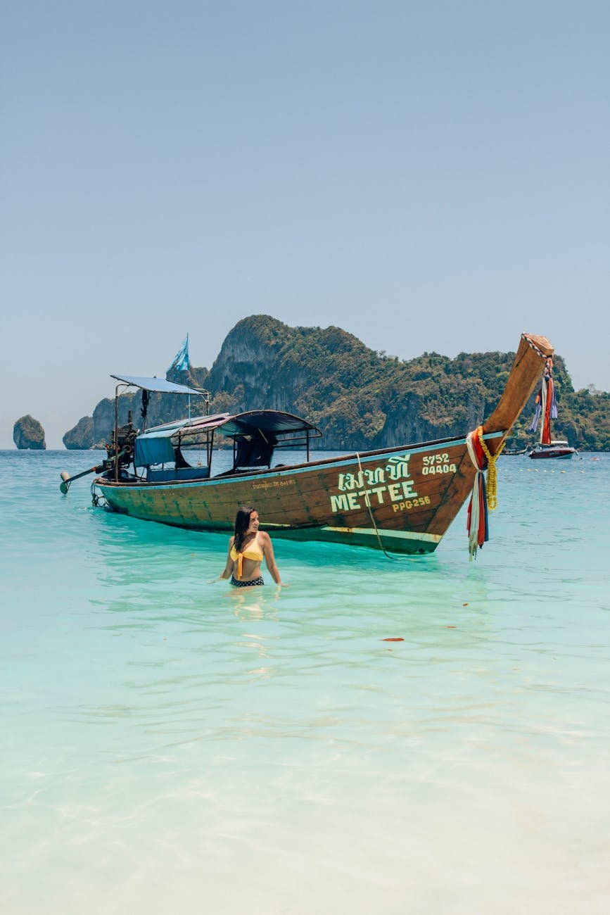 photo of woman standing near boat