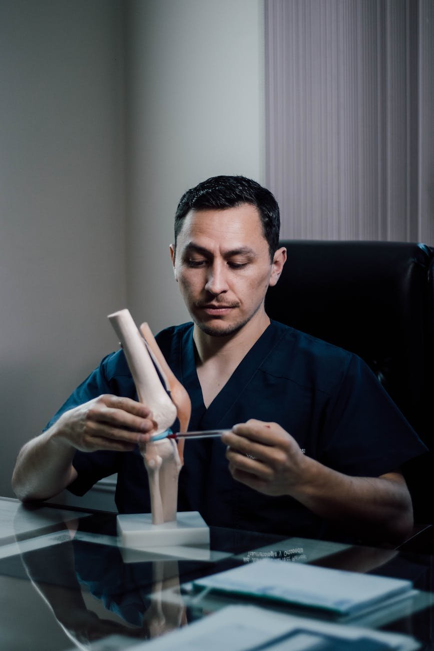doctor demonstrating knee joint anatomy in office