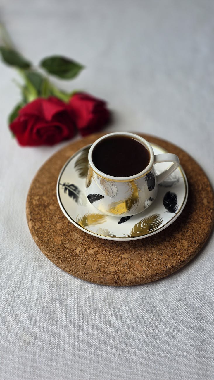 elegant coffee cup with red roses and saucer