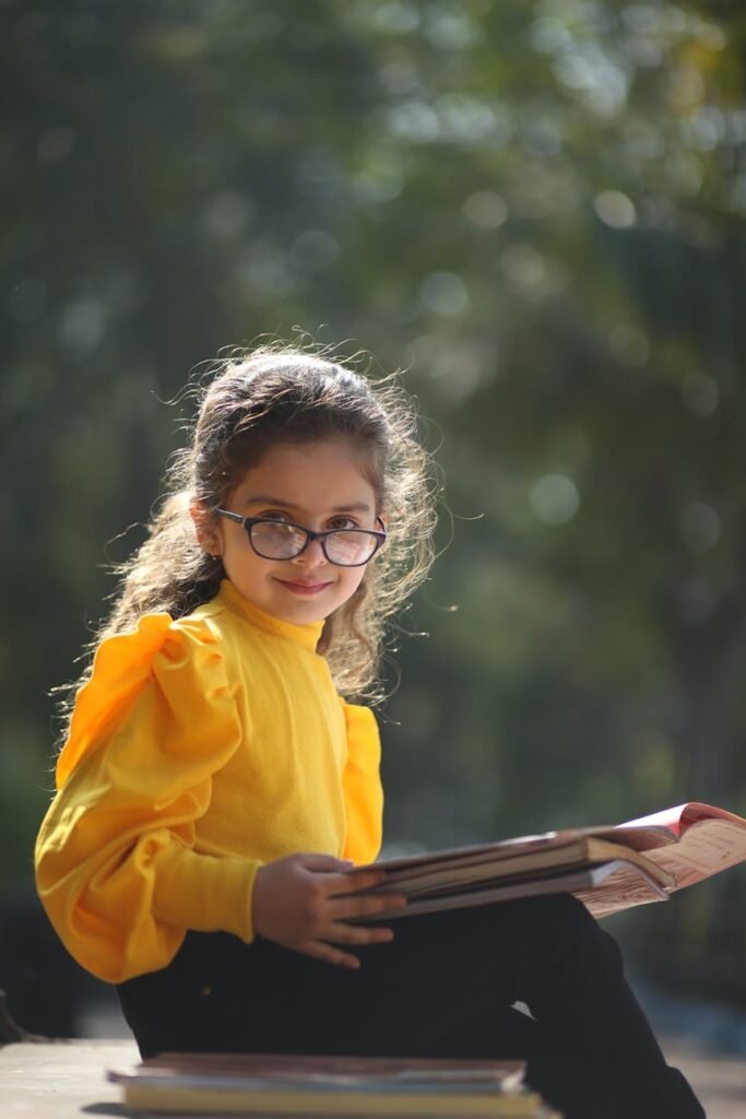 young girl reading book outdoors in india