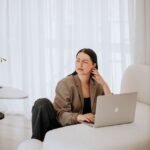 woman in business attire working on laptop