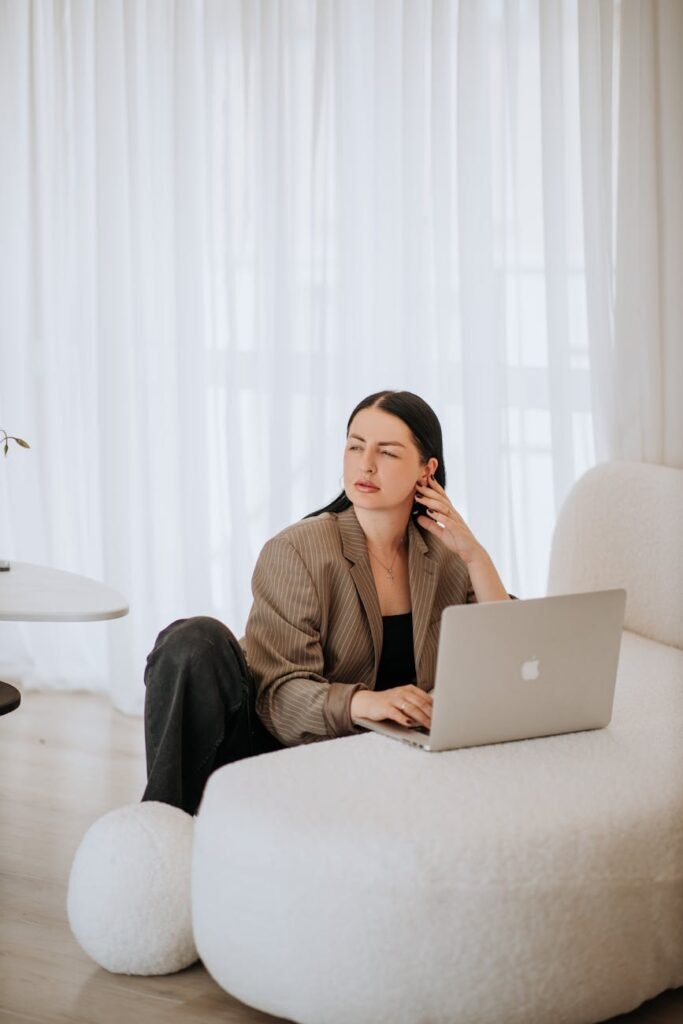 woman in business attire working on laptop