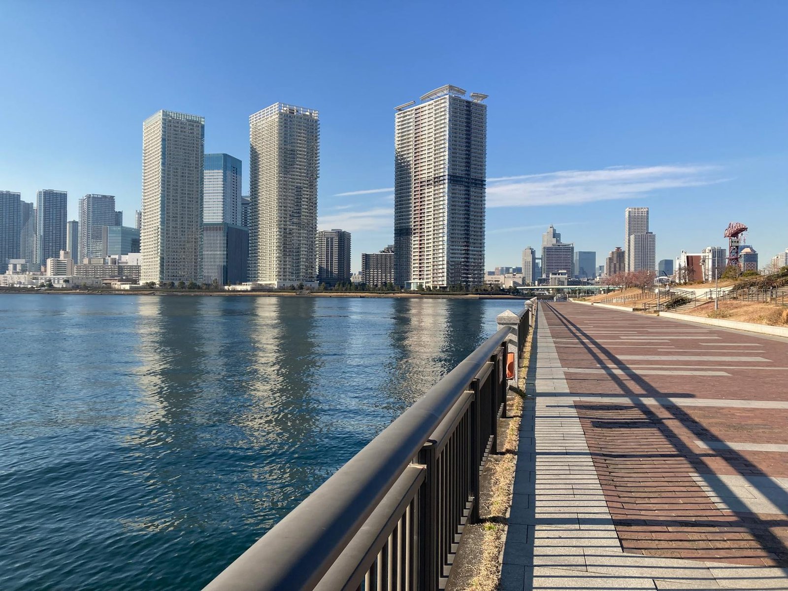 modern skyscrapers by tokyo waterfront promenade