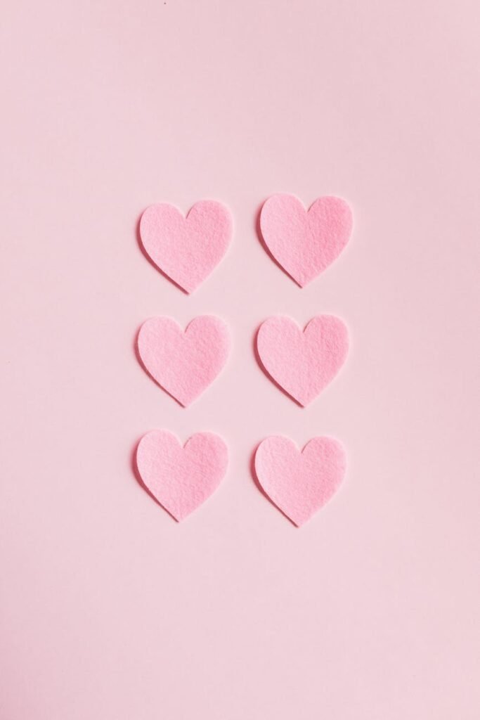 heart shaped cutouts on pink background