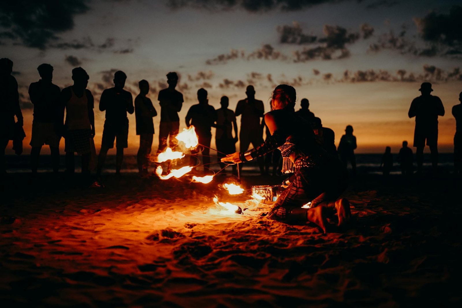 people standing on beach during sunset