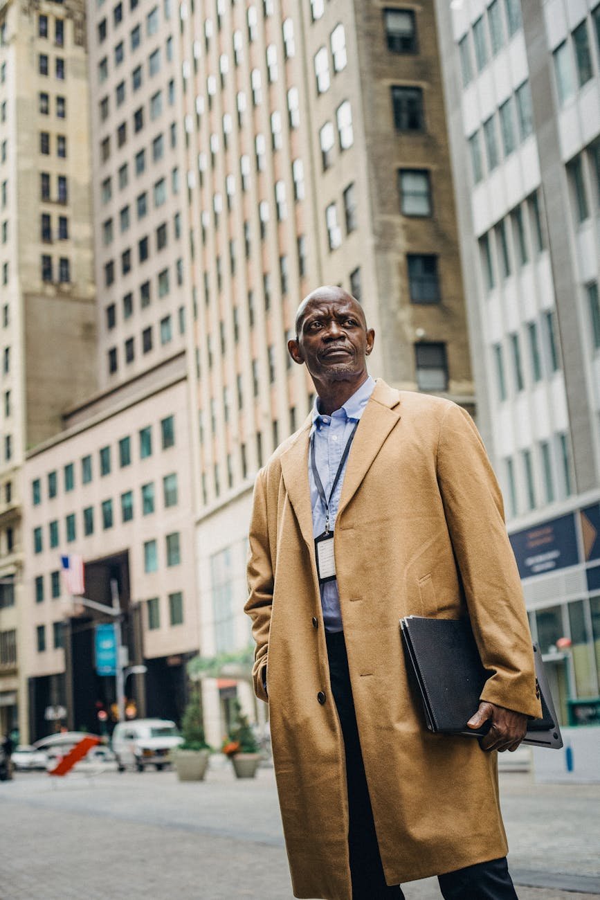 stylish black man in elegant outfit on street
