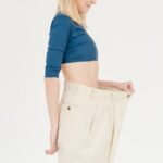 cheerful slender woman in oversized pants