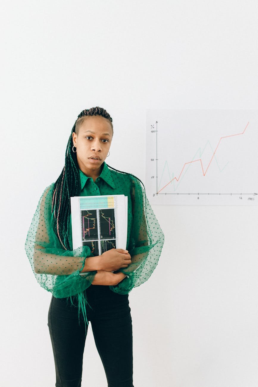 woman in green hijab holding book