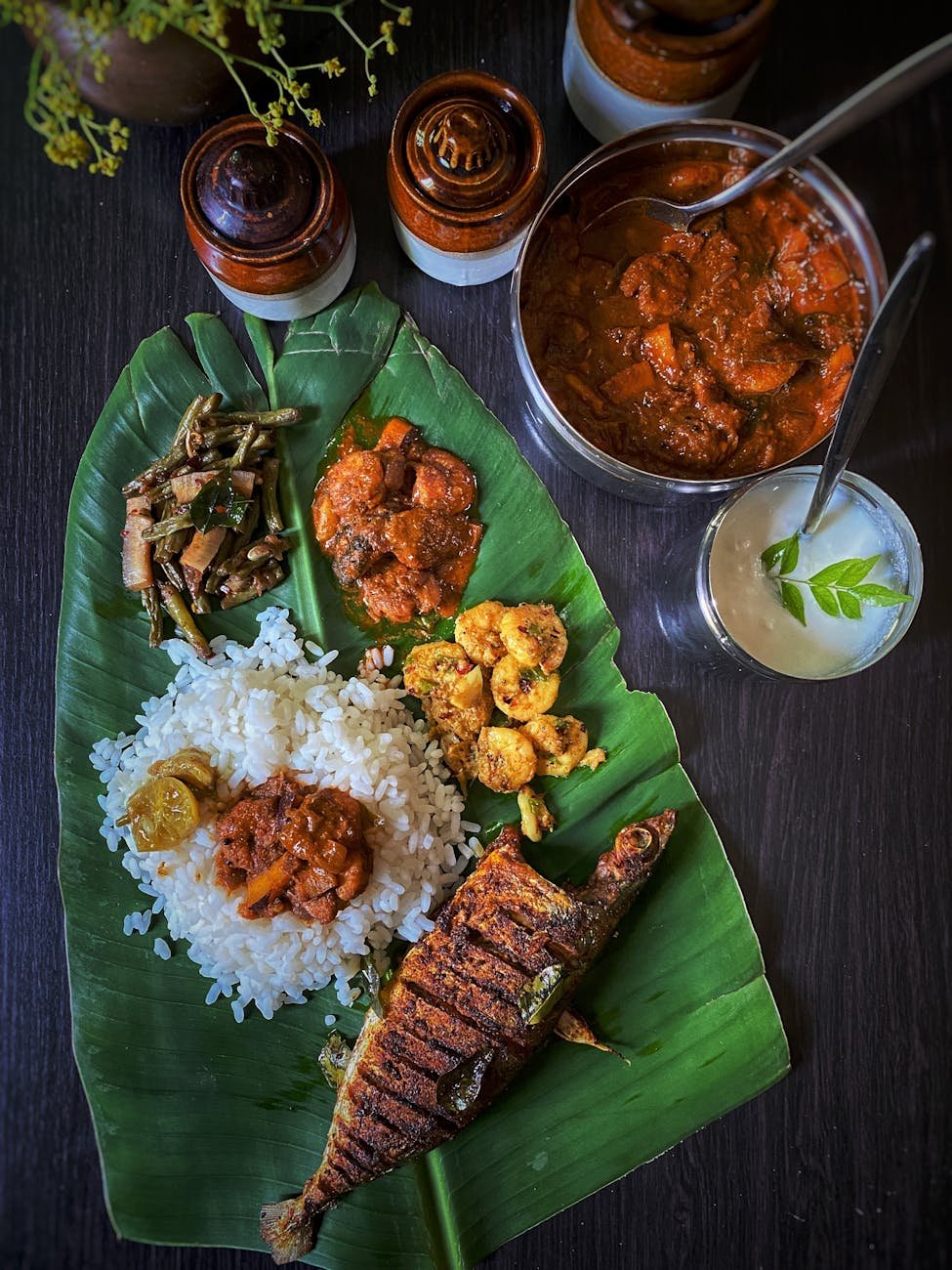 variety of cooked food on banana leaf