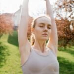 woman in brown tank top stretching