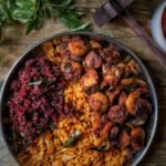 close up shot of delicious paella in stainless bowl