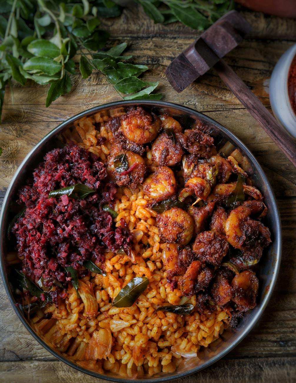 close up shot of delicious paella in stainless bowl