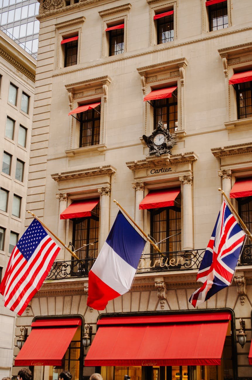 flags of usa france and united kingdom on cartier building in new york city
