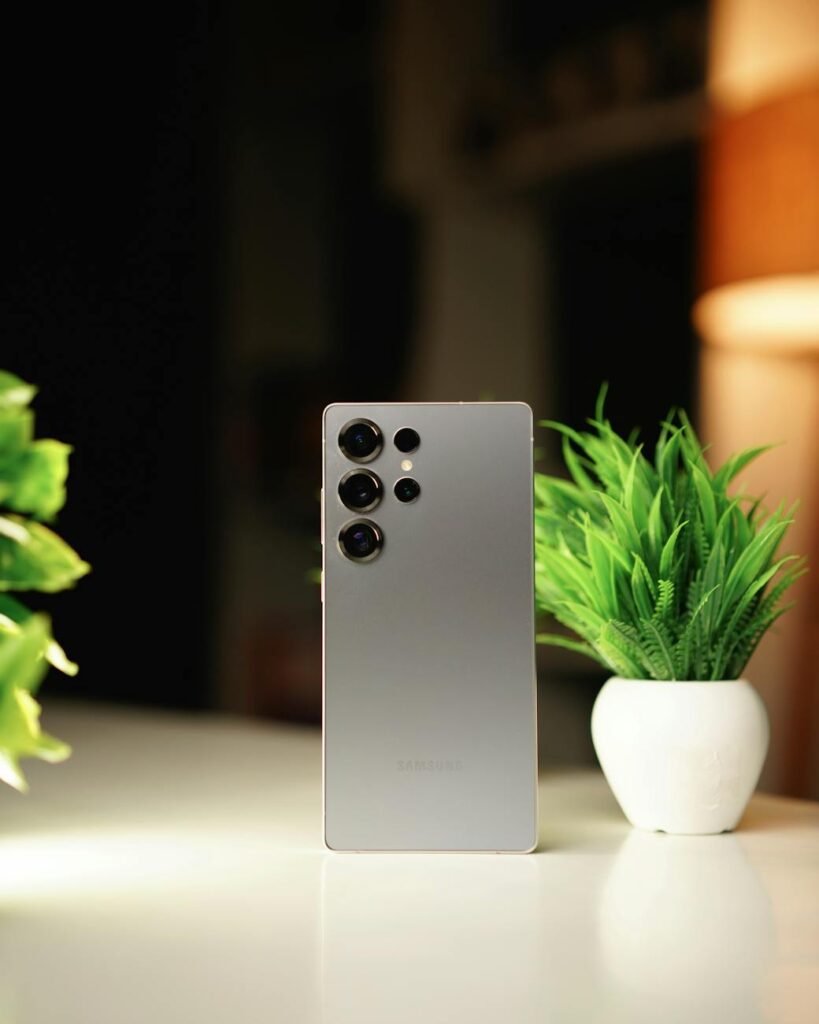 elegant smartphone beside potted plants on desk