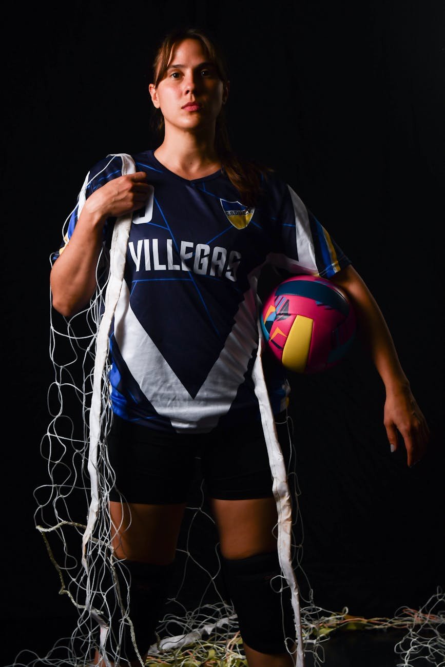 female volleyball player with ball and net