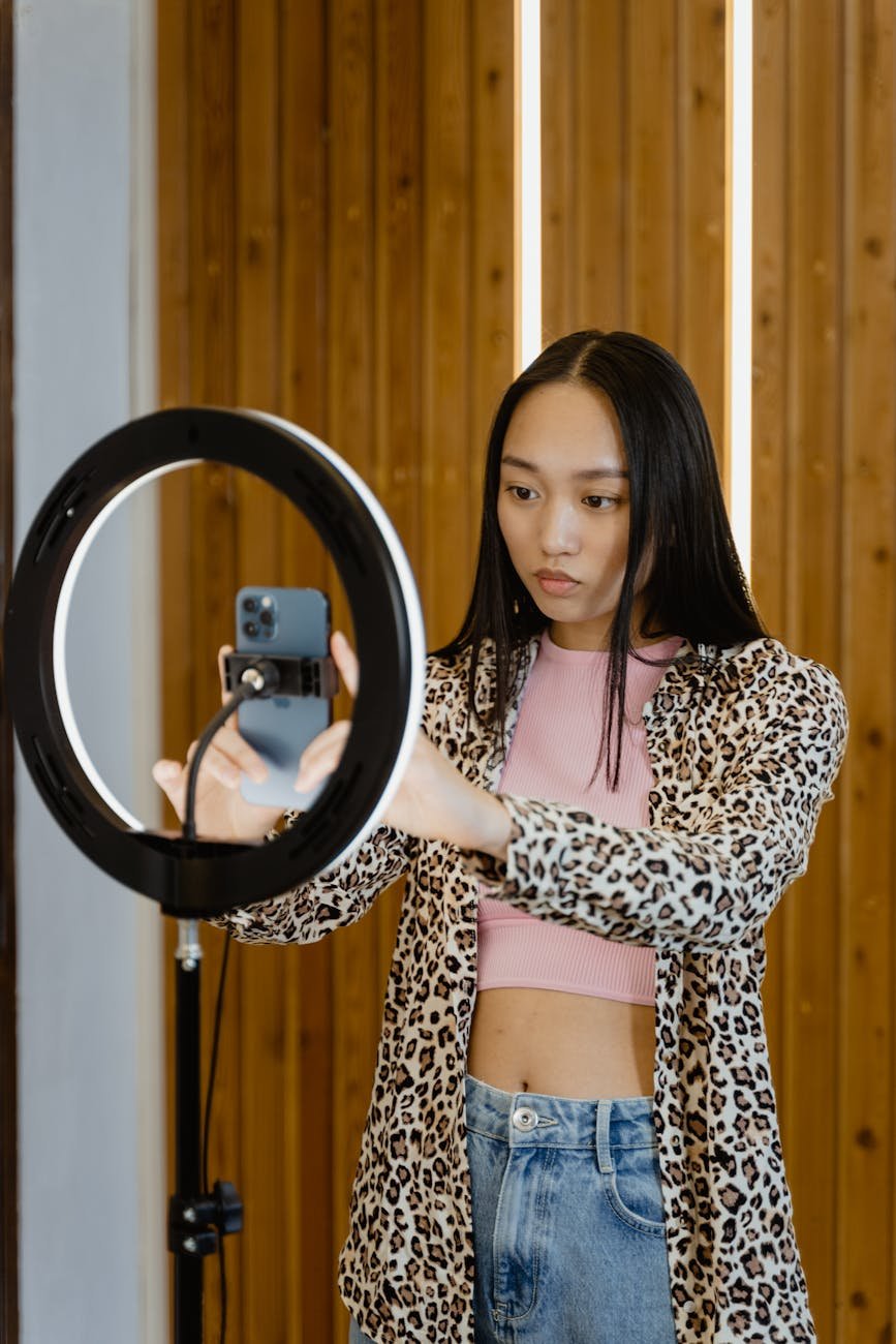 woman in print long sleeves holding a cellphone