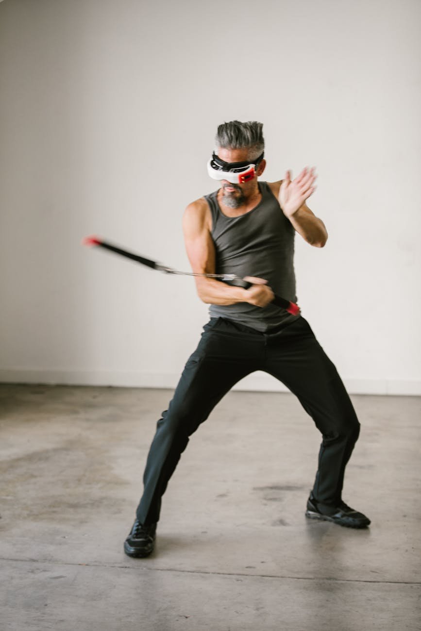 man using nunchaku while wearing virtual reality glasses