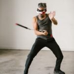 man using nunchaku while wearing virtual reality glasses