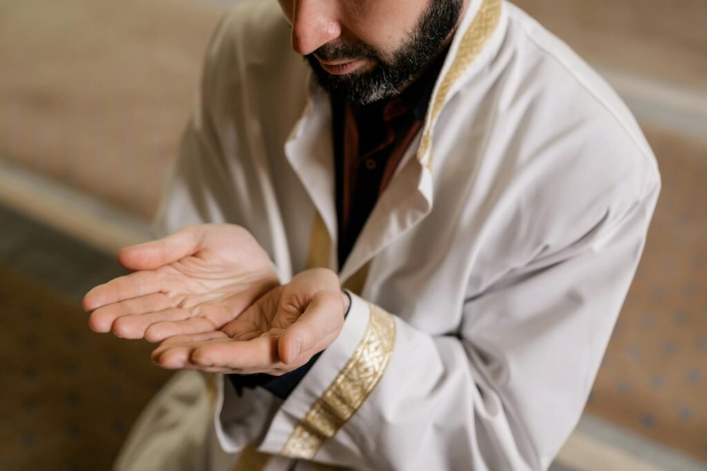 a man in white thobe kneeling