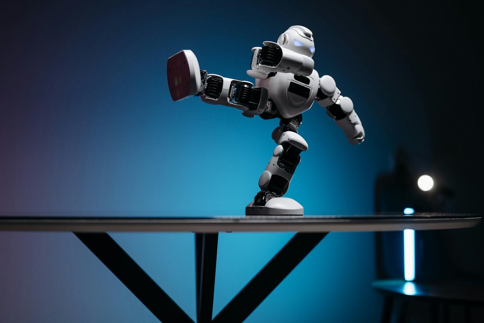 a white robot with leg raised sideways