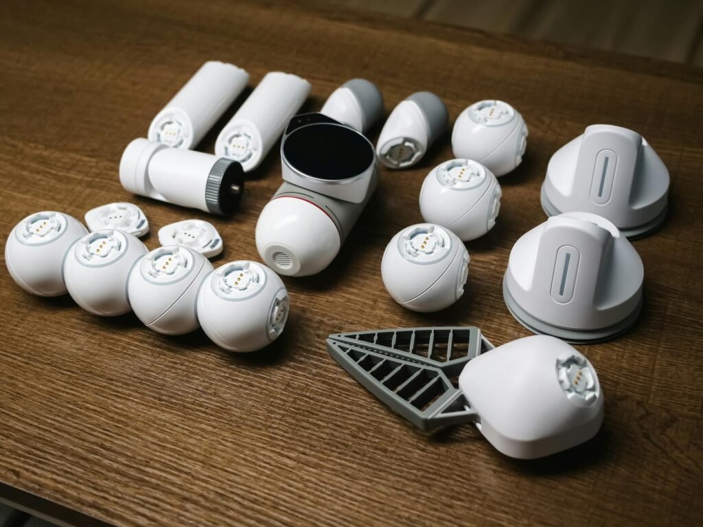 an unassembled clicbot on a wooden surface