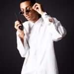 young man in a white shirt and sunglasses