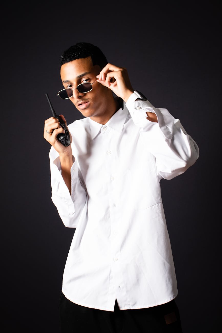 young man in a white shirt and sunglasses