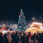 crowds of people on a christmas market square at night