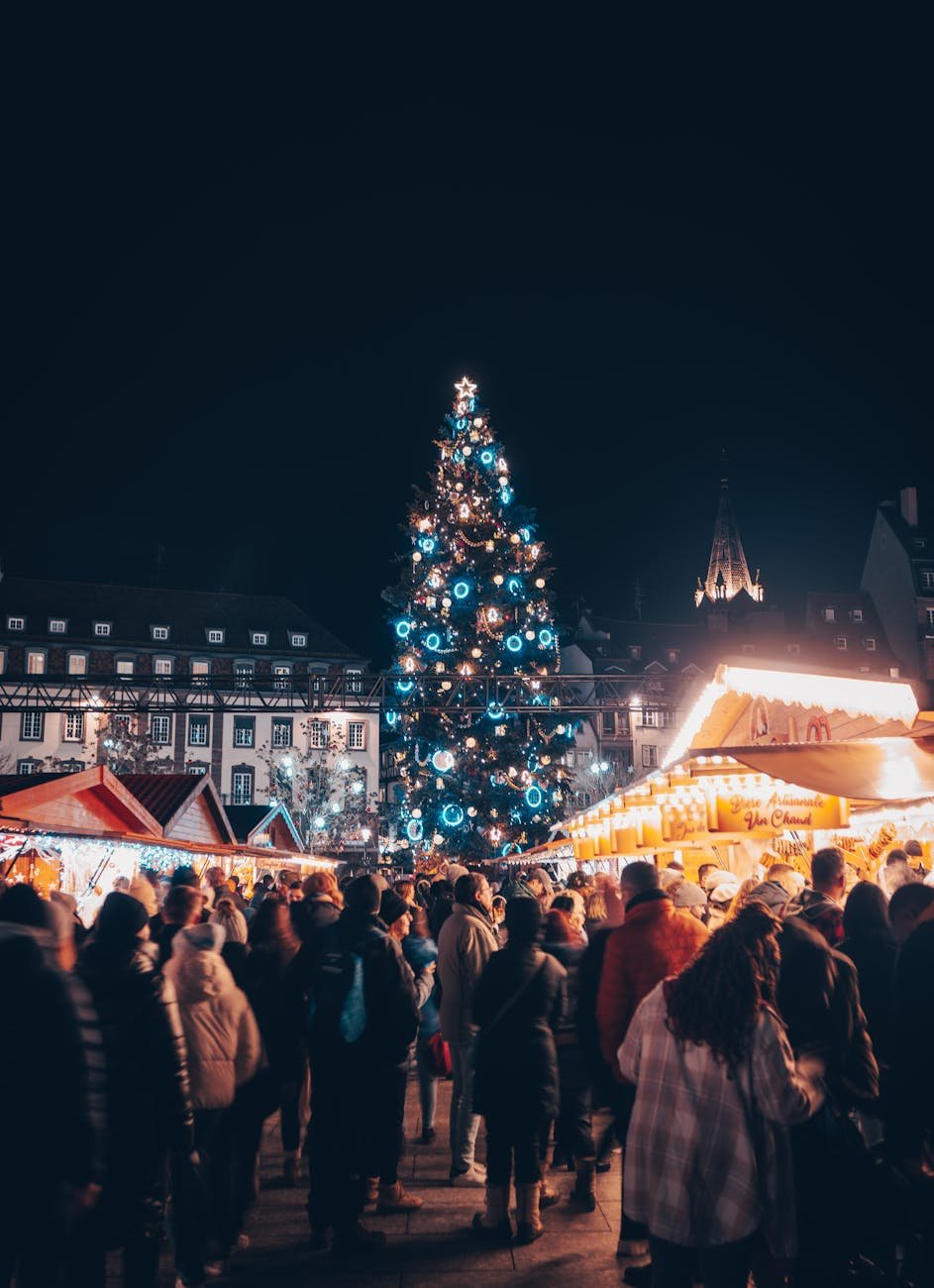 crowds of people on a christmas market square at night