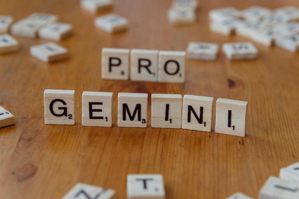 scrabble tiles spelling pro gemini on wooden table