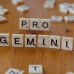 scrabble tiles spelling pro gemini on wooden table