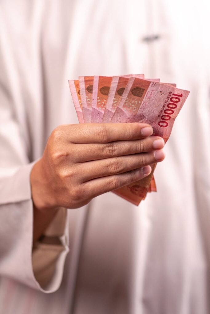 hand holding indonesian rupiah banknotes