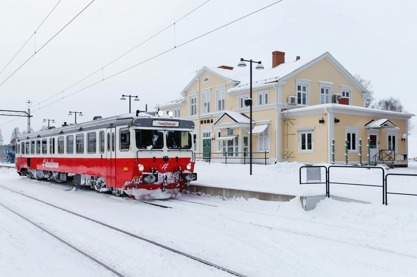 red and white train on snow covered ground