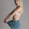 woman in white brassiere and blue denim pants