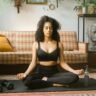woman in black activewear meditating indoors