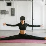 woman doing yoga while wearing virtual reality goggles