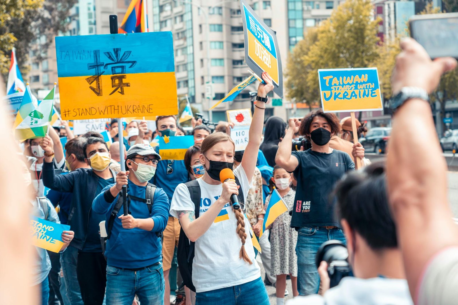 crowd with ukrainian flags on street