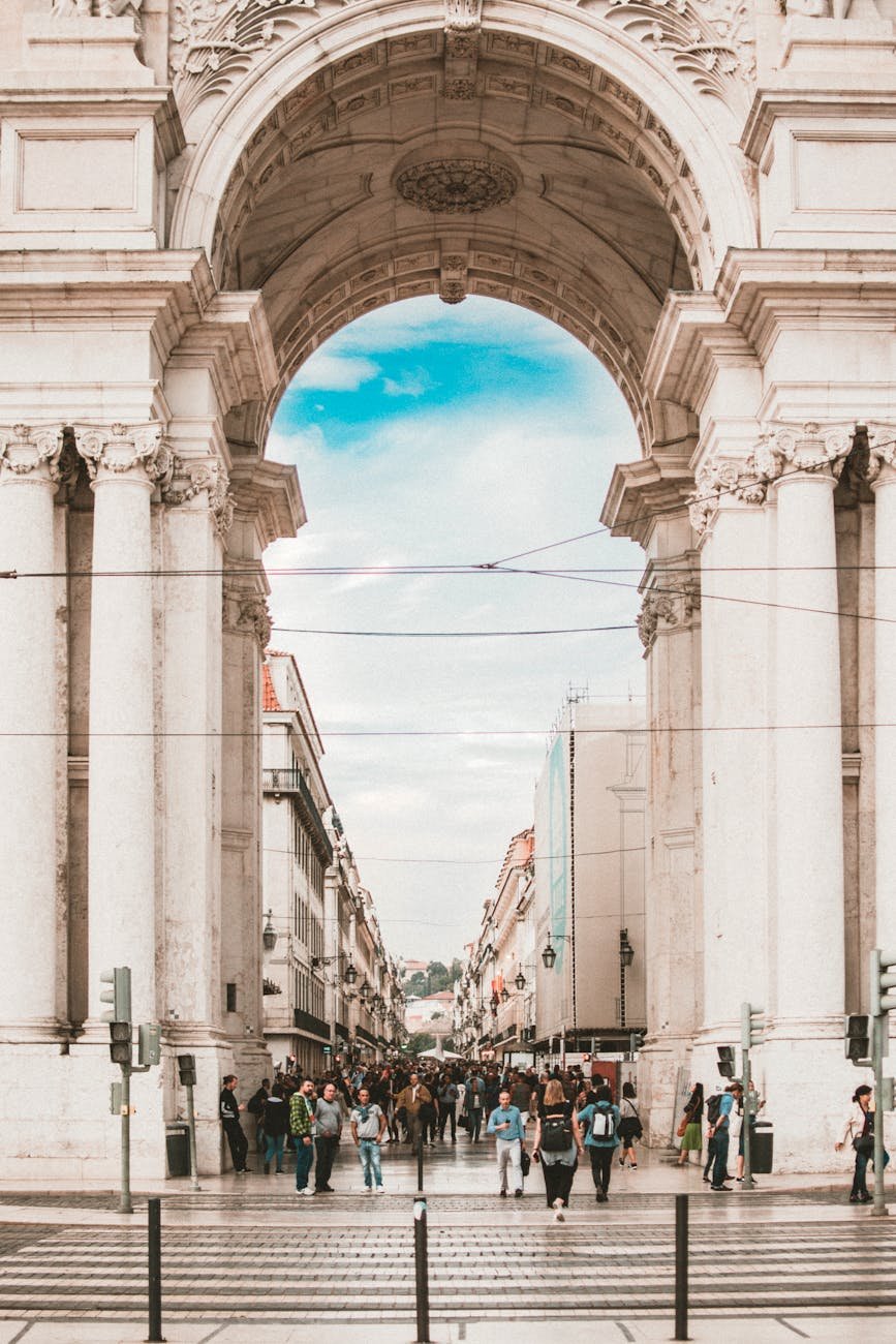 people walking under white concrete architecture