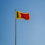 sri lankan national flag against clear blue sky