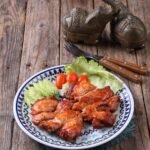 grilled chicken with lettuce and tomatoes on rustic table