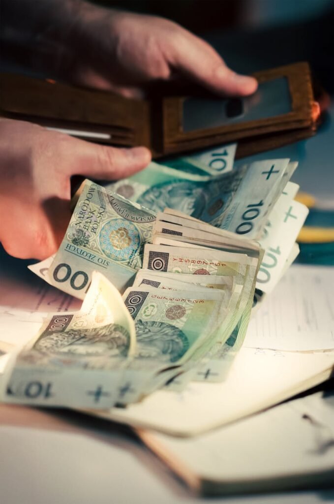 counting polish zloty banknotes from wallet